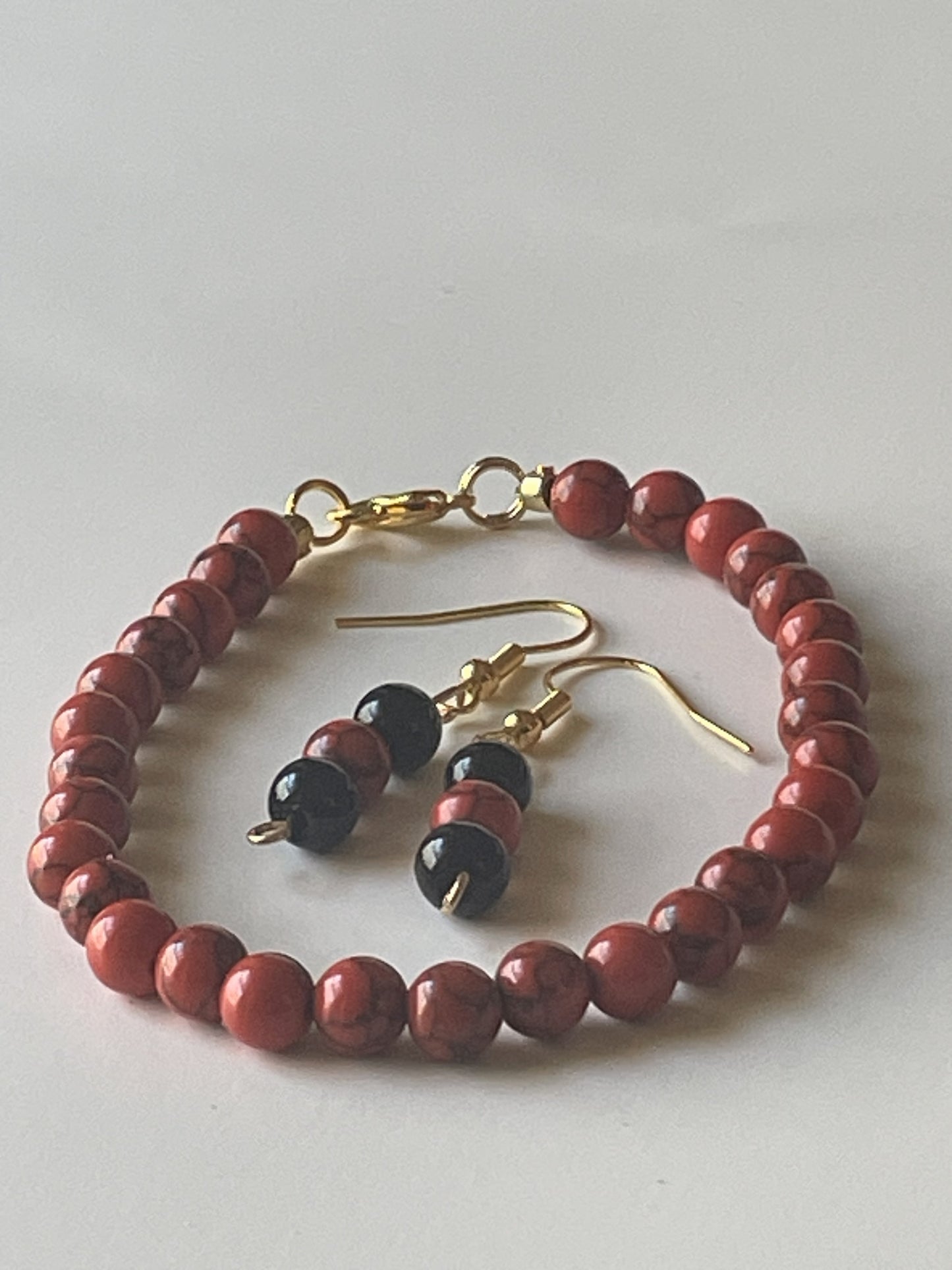 Sylvia Leroux red stone bead bracelet and matching earrings set, 7-inch bracelet with 1-inch dangle, gold lobster clasp, black onyx beads