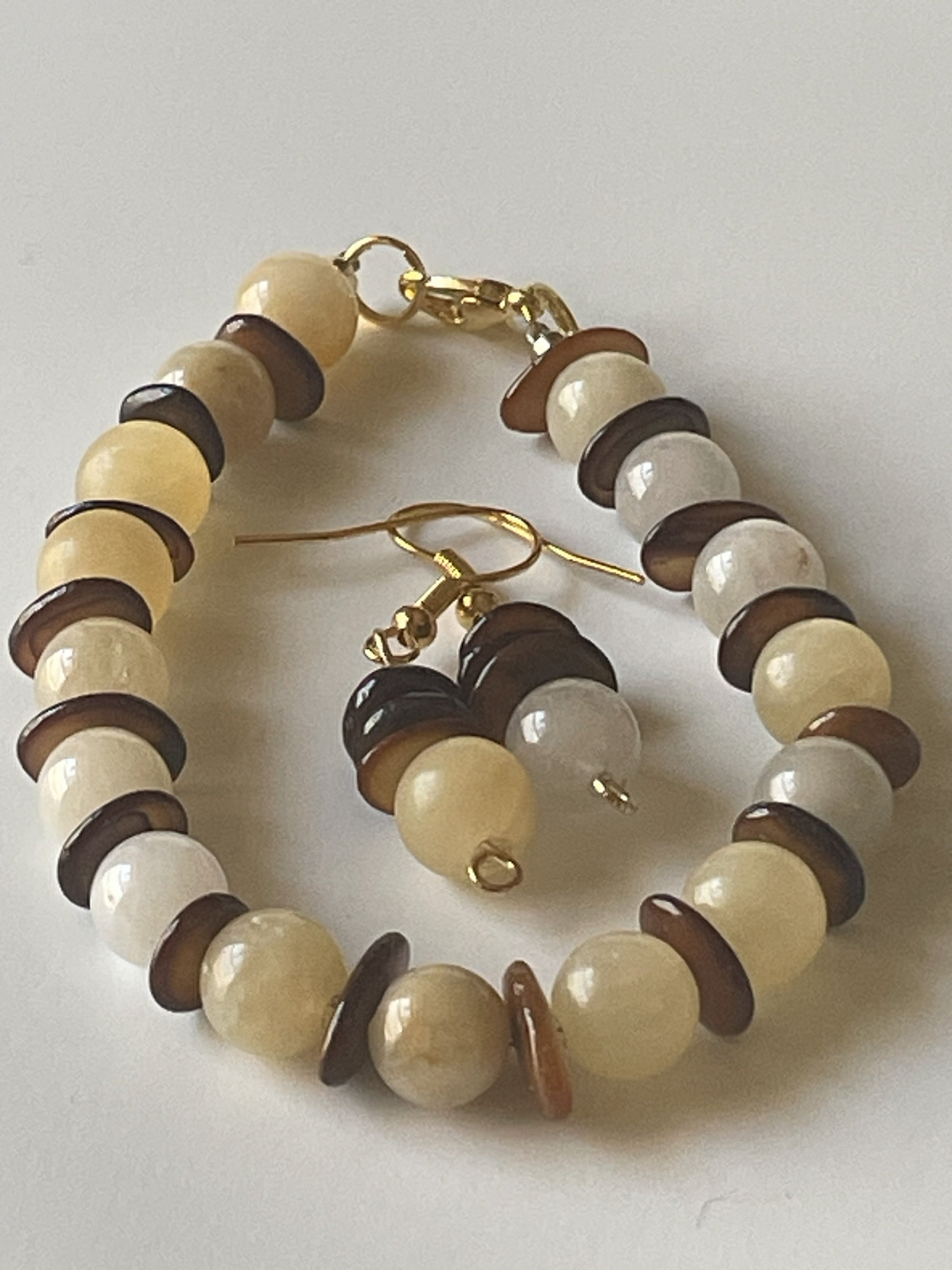 Pale yellow agate bracelet and matching earrings set with 8mm beads, gold lobster clasp, and shell accents by Sylvia Leroux.