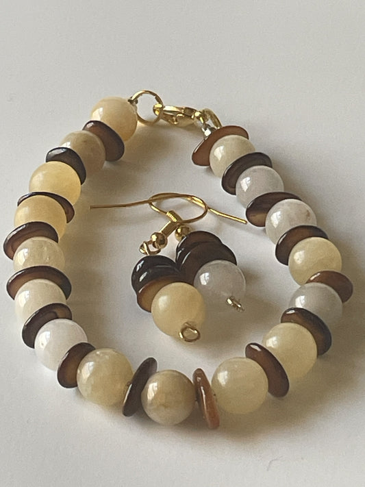 Pale yellow agate bracelet and matching earrings set with 8mm beads, gold lobster clasp, and shell accents by Sylvia Leroux.