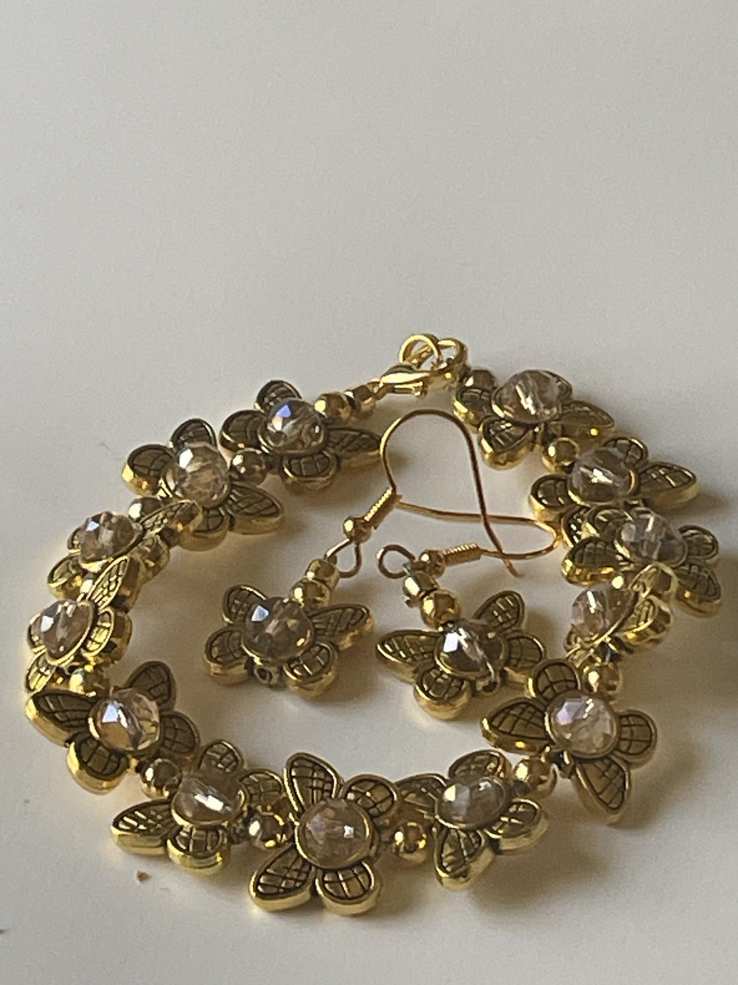 Gold butterfly bead bracelet with matching dangle earrings, Sylvia Leroux jewelry set featuring amber and gold alloy beads.