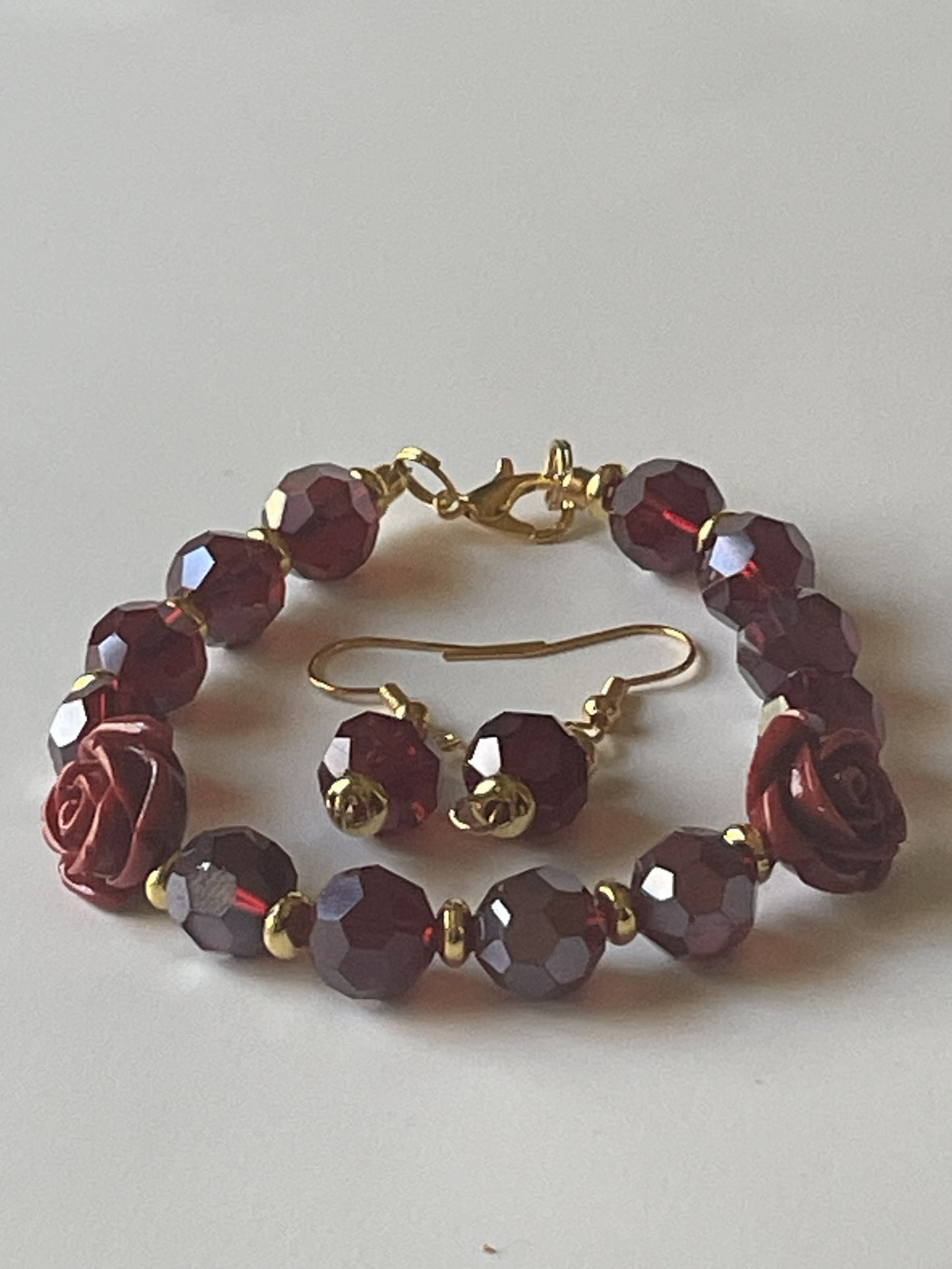 Sylvia Leroux wine faceted bead bracelet with matching dangle earrings, featuring 10mm wine beads, rose resin beads, and gold accents.