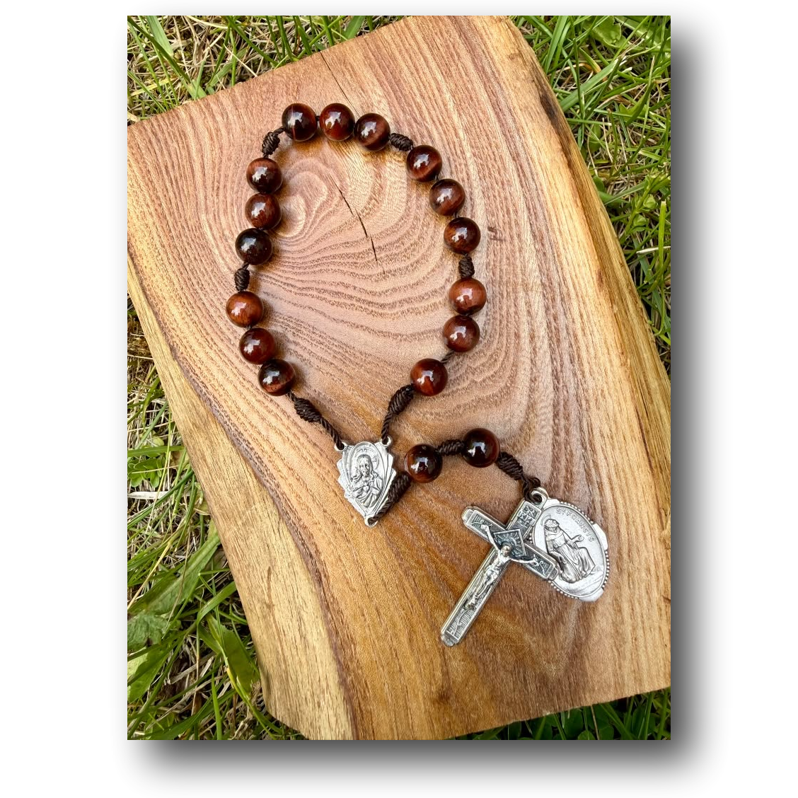 Catholic rosary chaplet with tiger’s eye beads featuring Sacred Heart and Saint Francis medal, designed for Christian prayer.