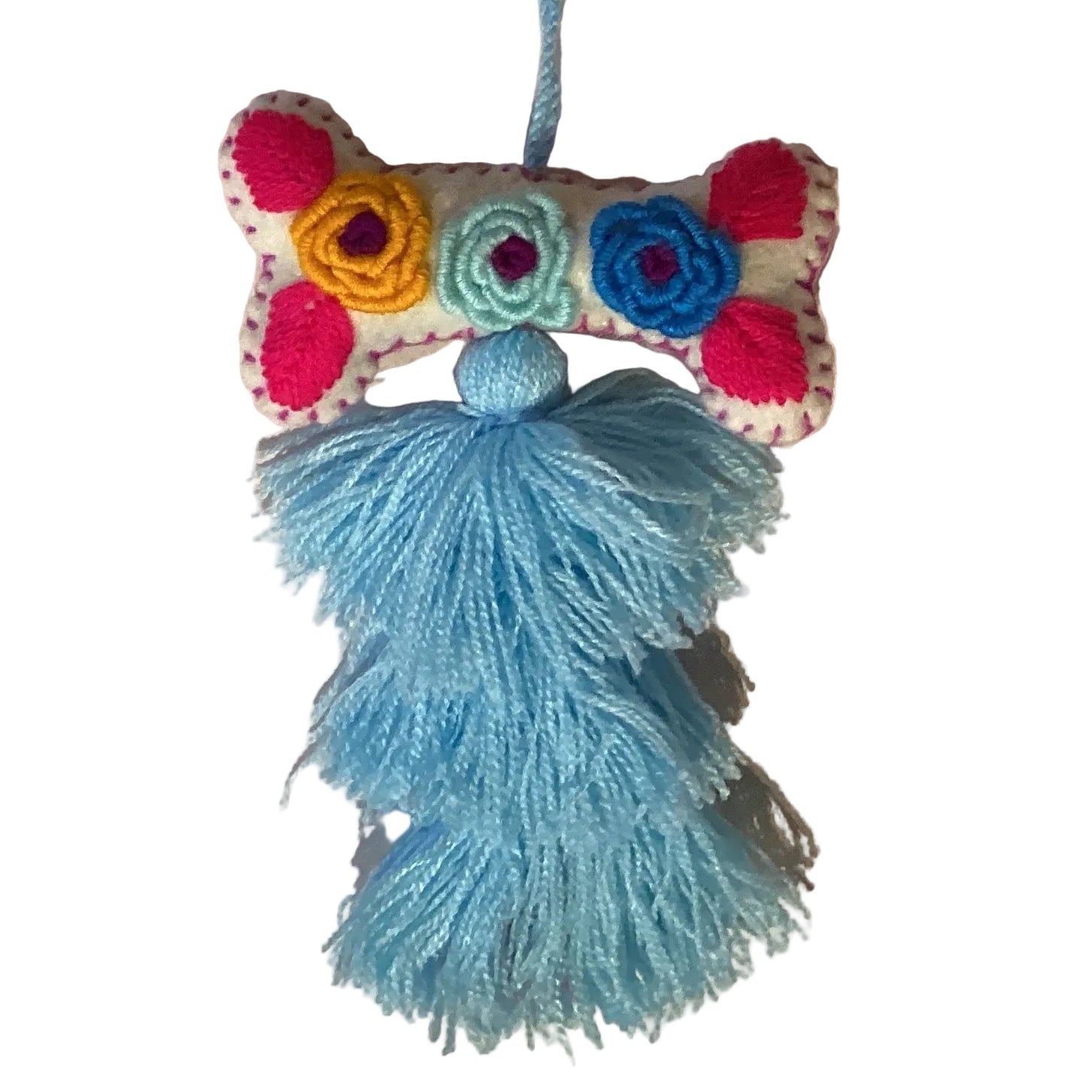 Handcrafted Mexican embroidered dog bone charm tassel accessory by Jose Alberto Chavez, featuring colorful embroidery and artisan craftsmanship.
