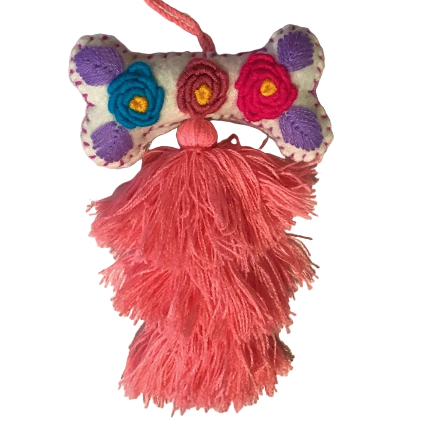 Handcrafted Mexican embroidered dog bone charm tassel accessory by Jose Alberto Chavez, featuring colorful embroidery and artisan details.