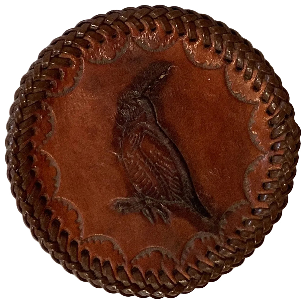 Leather embossed 3.5-inch coasters from Ysleta Mission Gift Shop displayed on a wooden table.