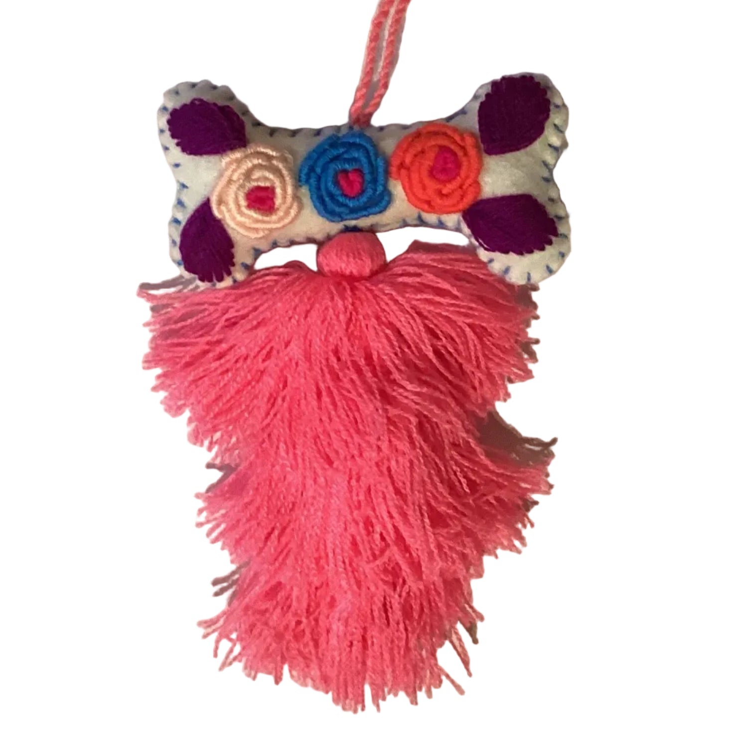 Handcrafted Mexican embroidered dog bone charm tassel from Jose Alberto Chavez, artisan accessory for bags and apparel.