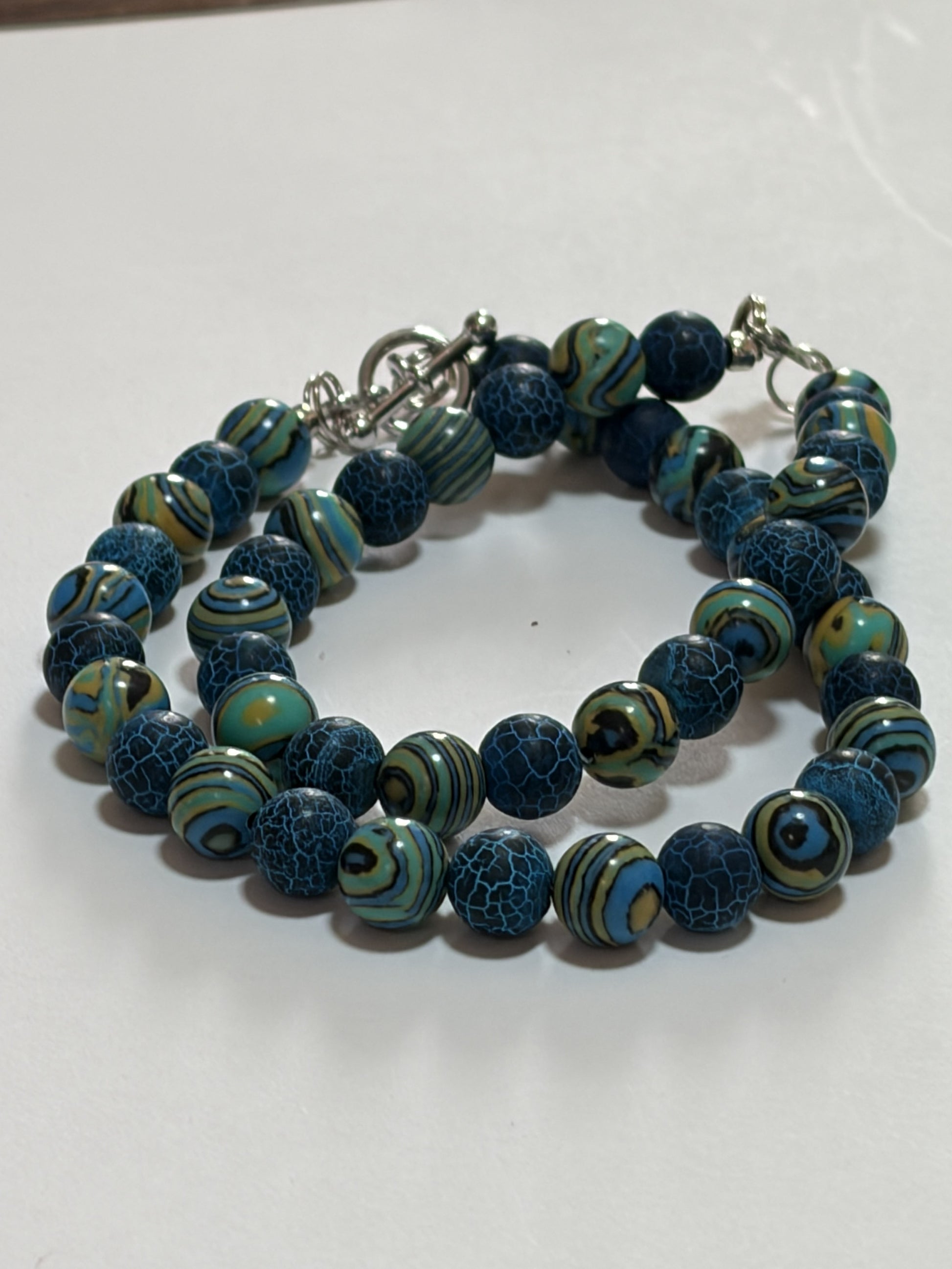 Natural round malachite couples bracelet with 8mm marbled beads, silver lobster and toggle clasps, by Sylvia Leroux.