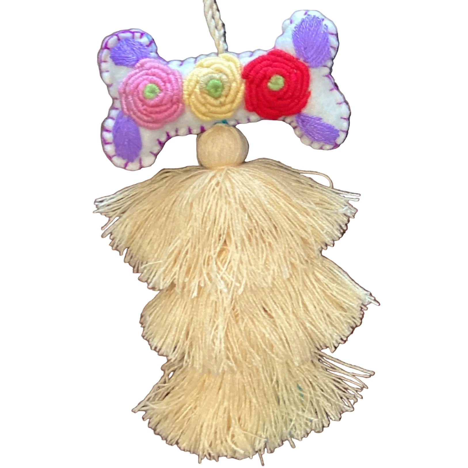 Handcrafted Mexican embroidered dog bone charm with tassel, by Jose Alberto Chavez, featuring colorful traditional textile details.