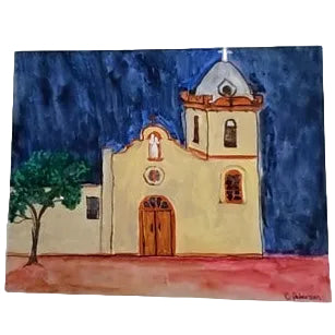 Original watercolor and gouache painting of Ysleta Mission at night by Cheryl Peterson, displayed on an easel, El Paso mission art.