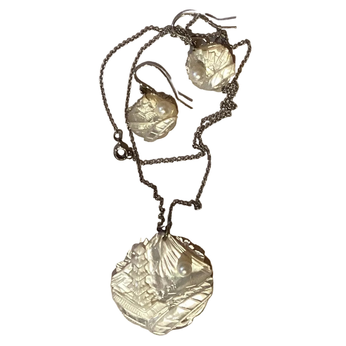 Mother of Pearl Chinese style necklace and earrings set featuring intricate jewelry design with lustrous pearl accents.
