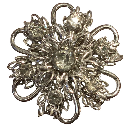 Silver-tone flower brooch with detailed floral design, 1.25 inches, crafted as a jewelry accessory with intricate metalwork.