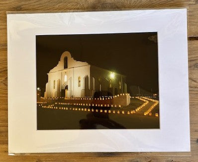 8x10 print of San Elizario Chapel with luminarias by Miguel Martinez, featuring a scenic nighttime view of the historic landmark.