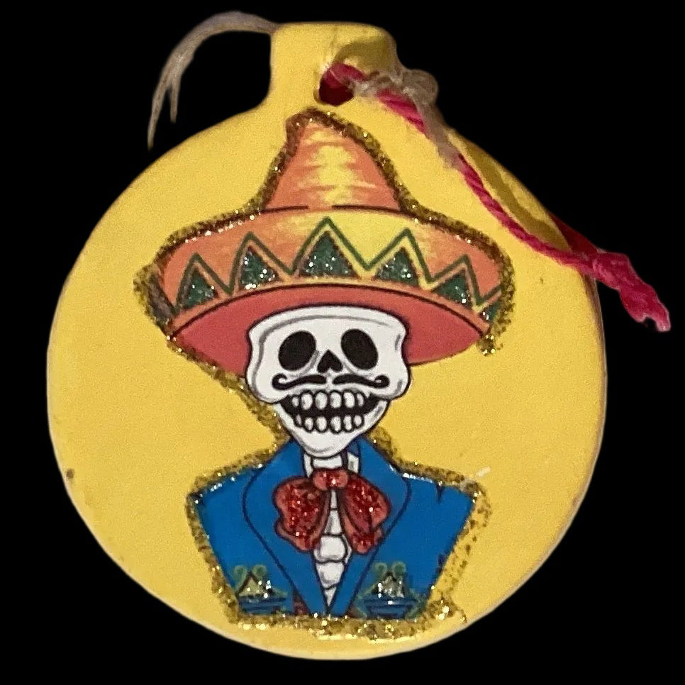 Colorful Día De Los Muertos ceramic ornament from Ysleta Mission Gift Shop, featuring traditional skull and floral designs.