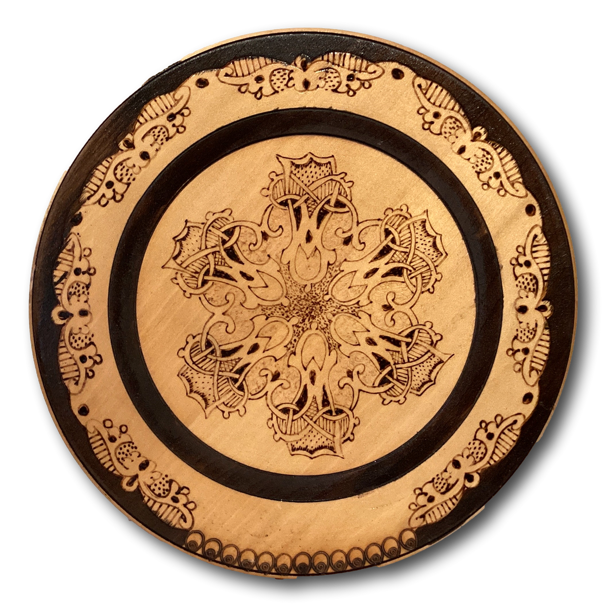 Wood burned decorative plate, 9 inches in diameter, featuring intricate designs, from Ysleta Mission Gift Shop for home decor.