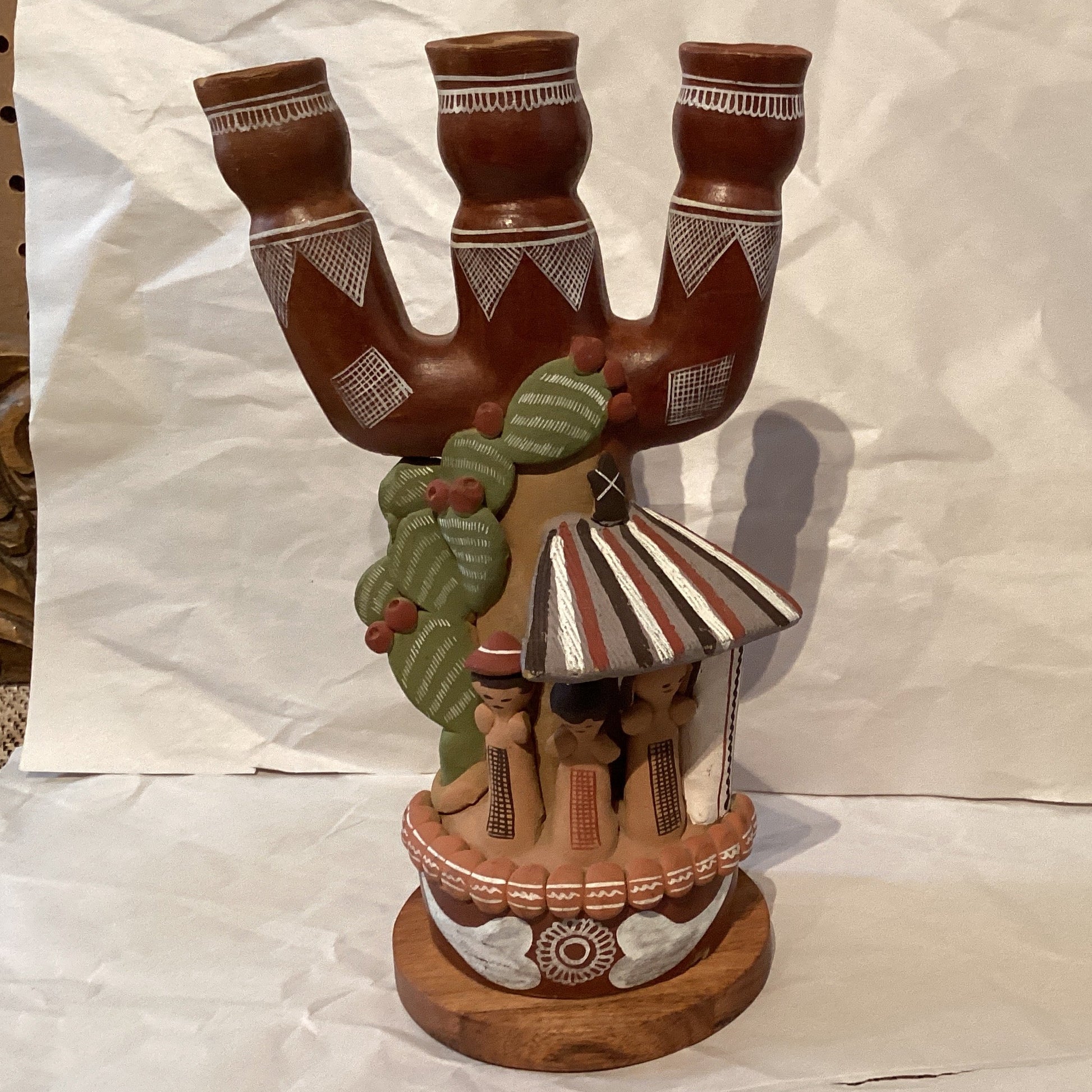 Peruvian 9-inch candle holder with intricate designs, crafted by Ysleta Mission Gift Shop, displayed on a wooden surface.