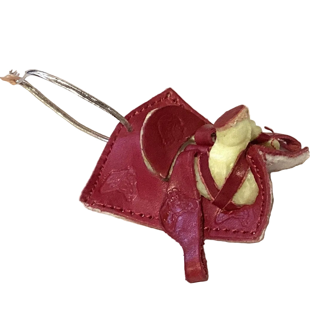 Mini leather saddle keychain from Ysleta Mission Gift Shop, Western cowboy style, with detailed saddle design and keyring attachment.