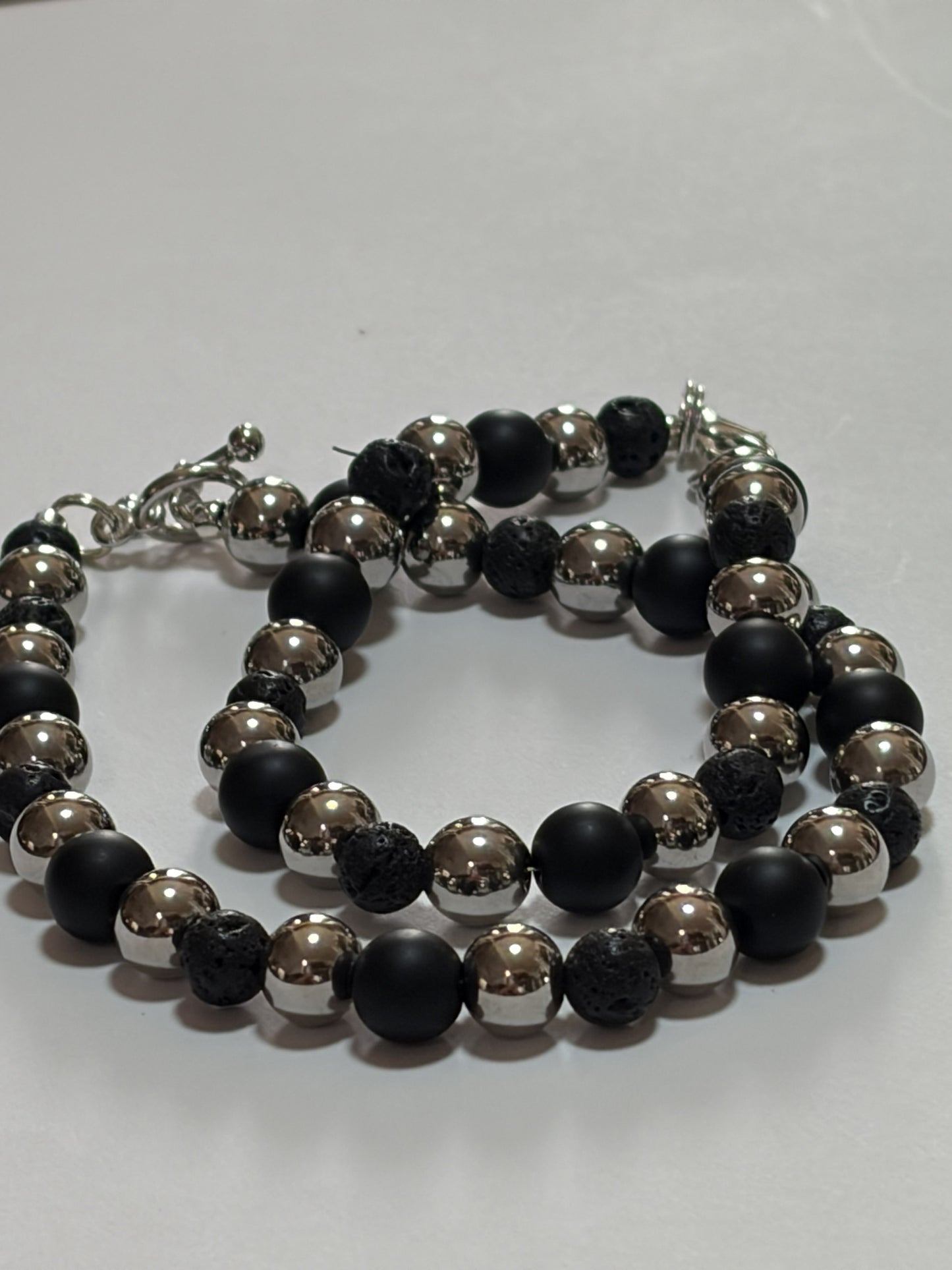 Silver Accent Stone Bracelet for couples, 10mm stainless steel jewelry with black lava and silver details, featuring lobster and toggle clasps.