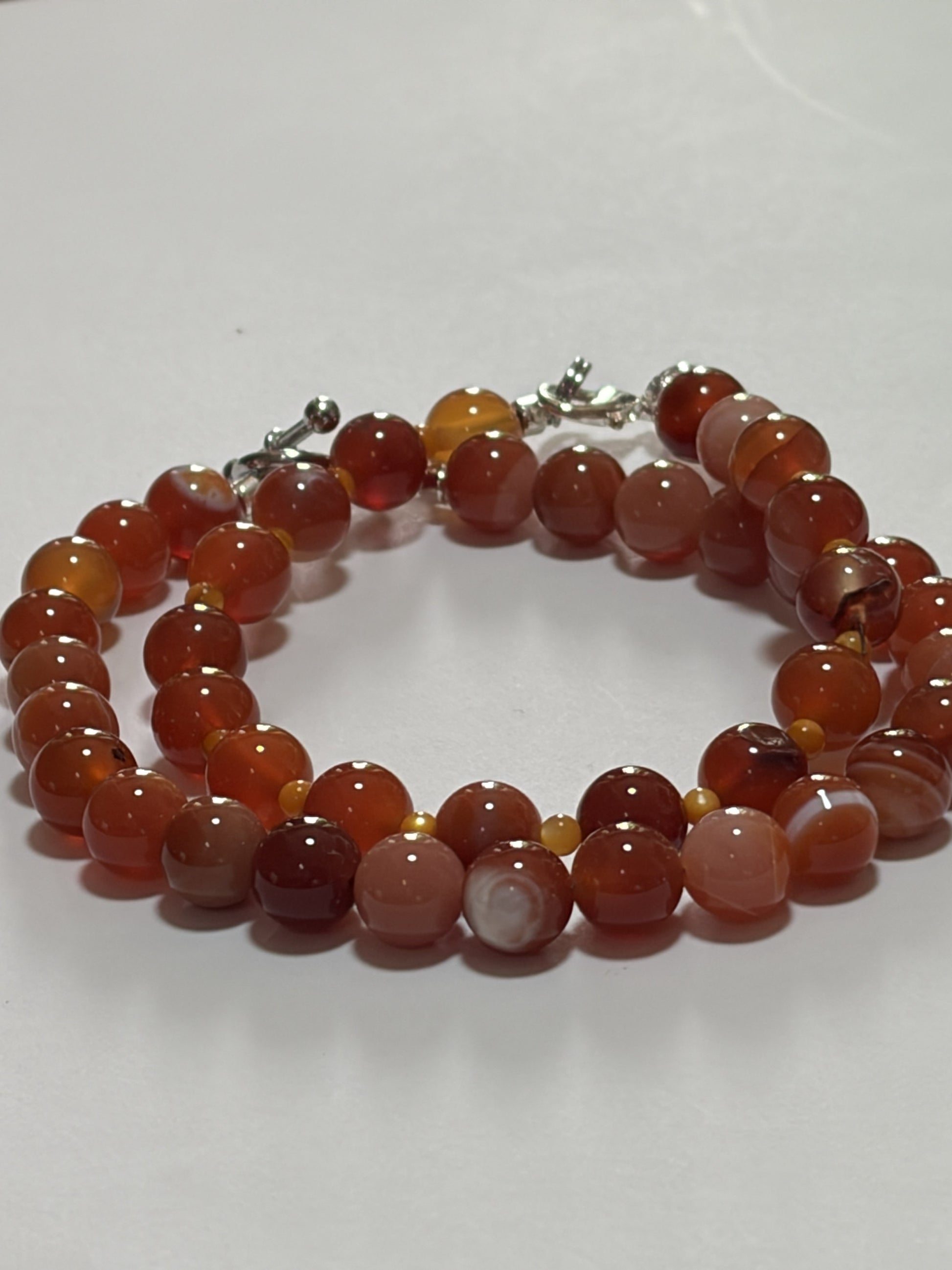 Natural gemstone couples bracelet set with 8mm red carnelian and striped agate beads, silver lobster and toggle clasps by Sylvia Leroux.