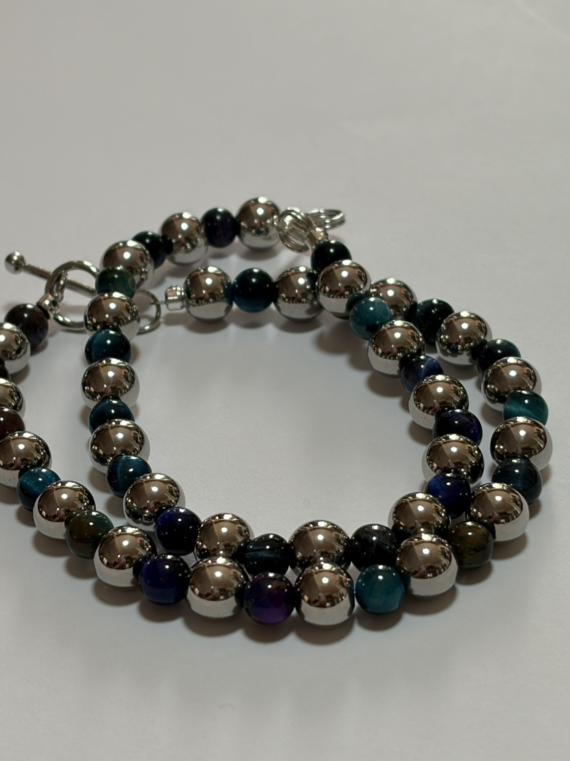 Blue stone couples bracelet set by Sylvia Leroux featuring 8mm stretch band, stainless steel with silver finish and lobster clasp.