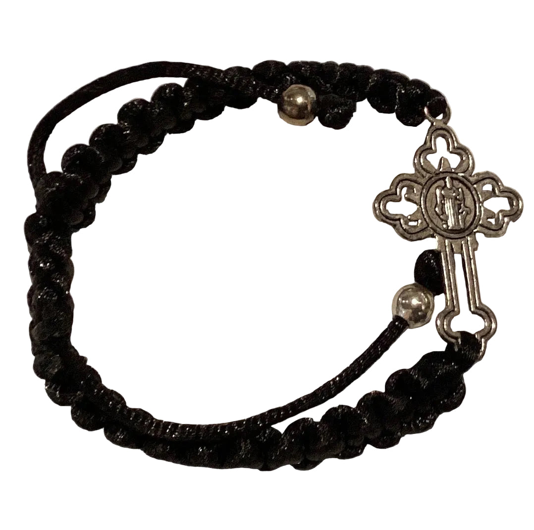Black cord Catholic bracelet with silver-tone Saint Benedict cross and medal, adjustable knotted design, Christian jewelry accessory.