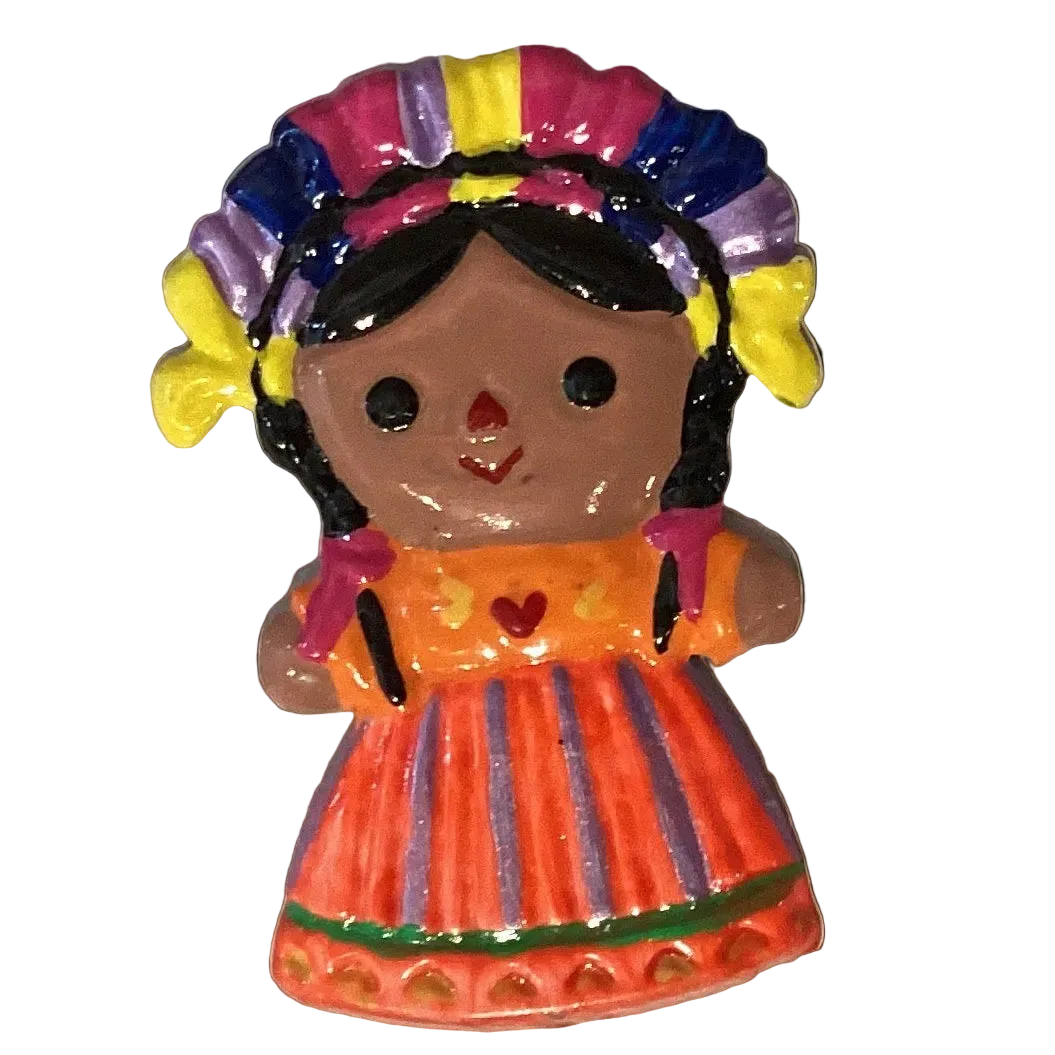 Little doll 3.5-inch tin magnet from Ysleta Mission Gift Shop, decorative refrigerator magnet featuring a colorful doll design.