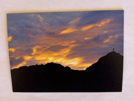 Magnet cross on mountain design souvenir by Miguel Martinez, featuring a grey mountain scene with a cross motif.