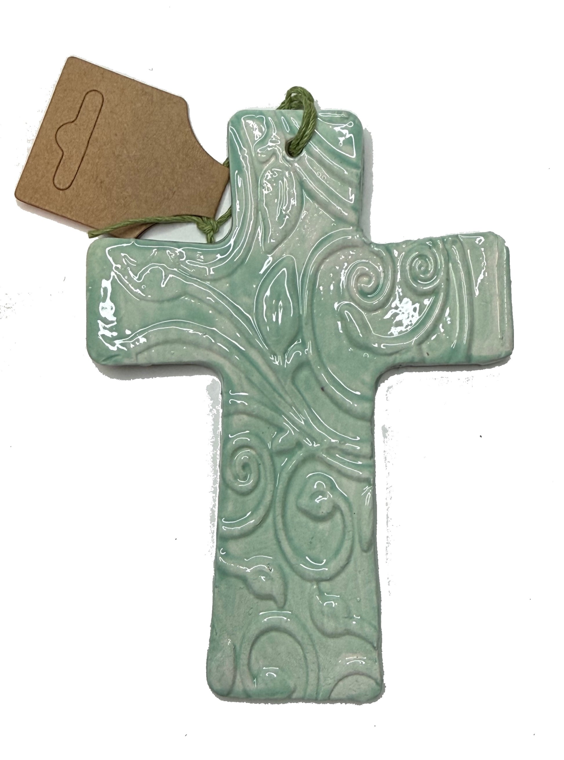 Light green ceramic cross by Lorena Williams featuring a smooth finish and decorative design, perfect for home decor.