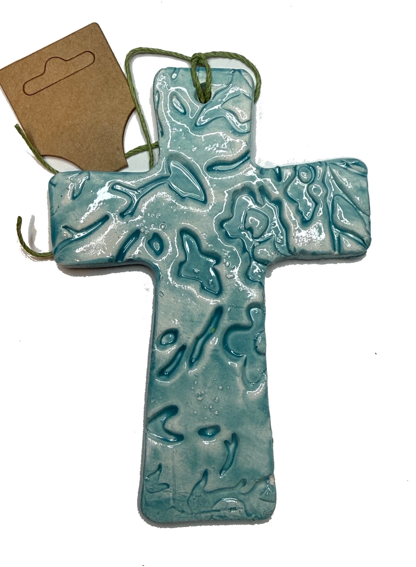 Teal floral ceramic cross by Lorena Williams, featuring intricate floral patterns on a smooth ceramic surface.