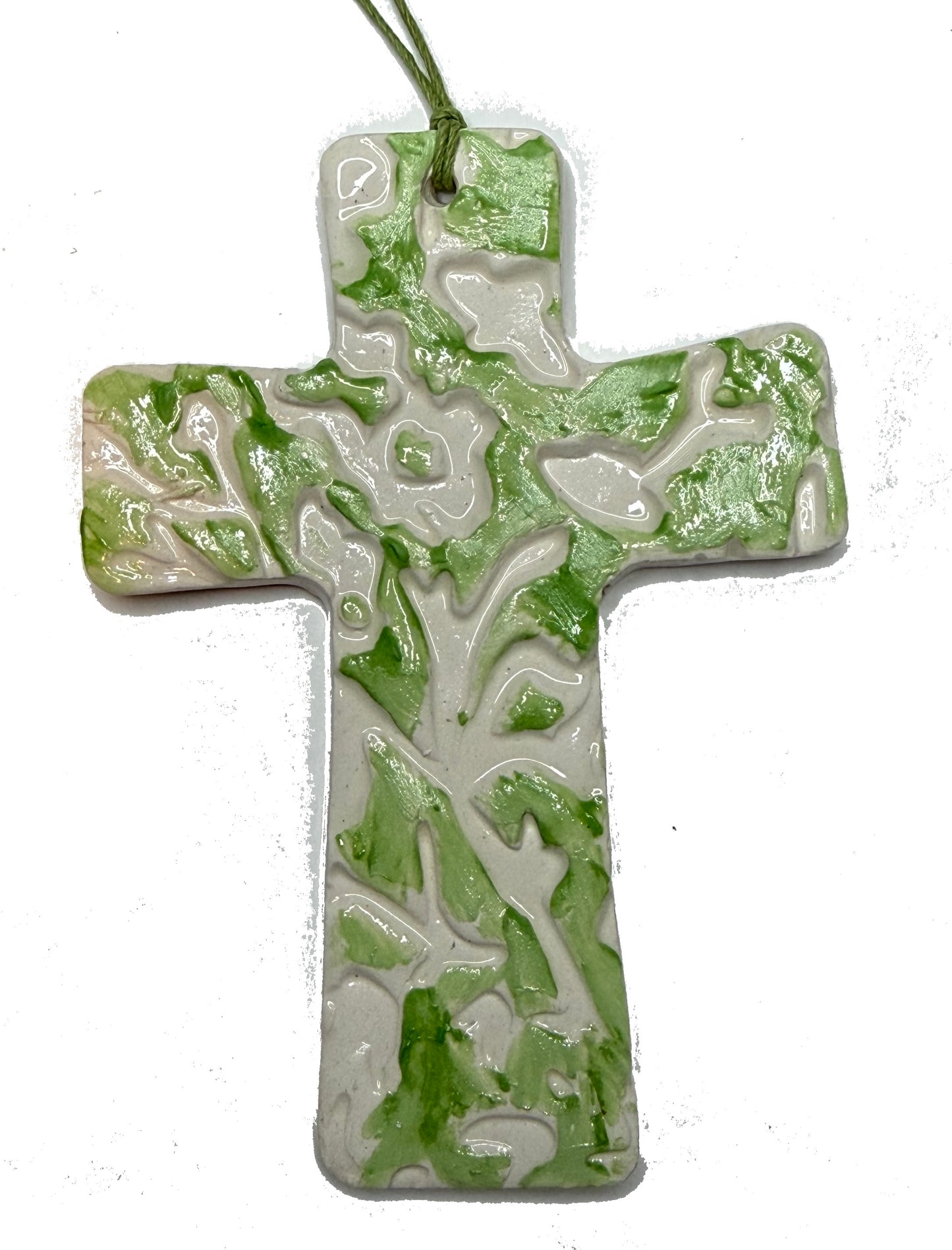Green floral ceramic cross by Lorena Williams, featuring detailed floral patterns and a glossy finish.