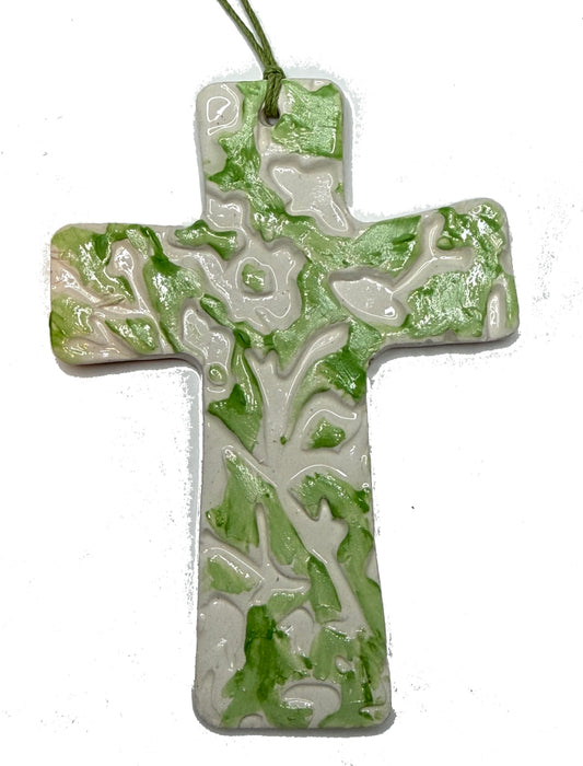 Green floral ceramic cross by Lorena Williams, featuring detailed floral patterns and a glossy finish.