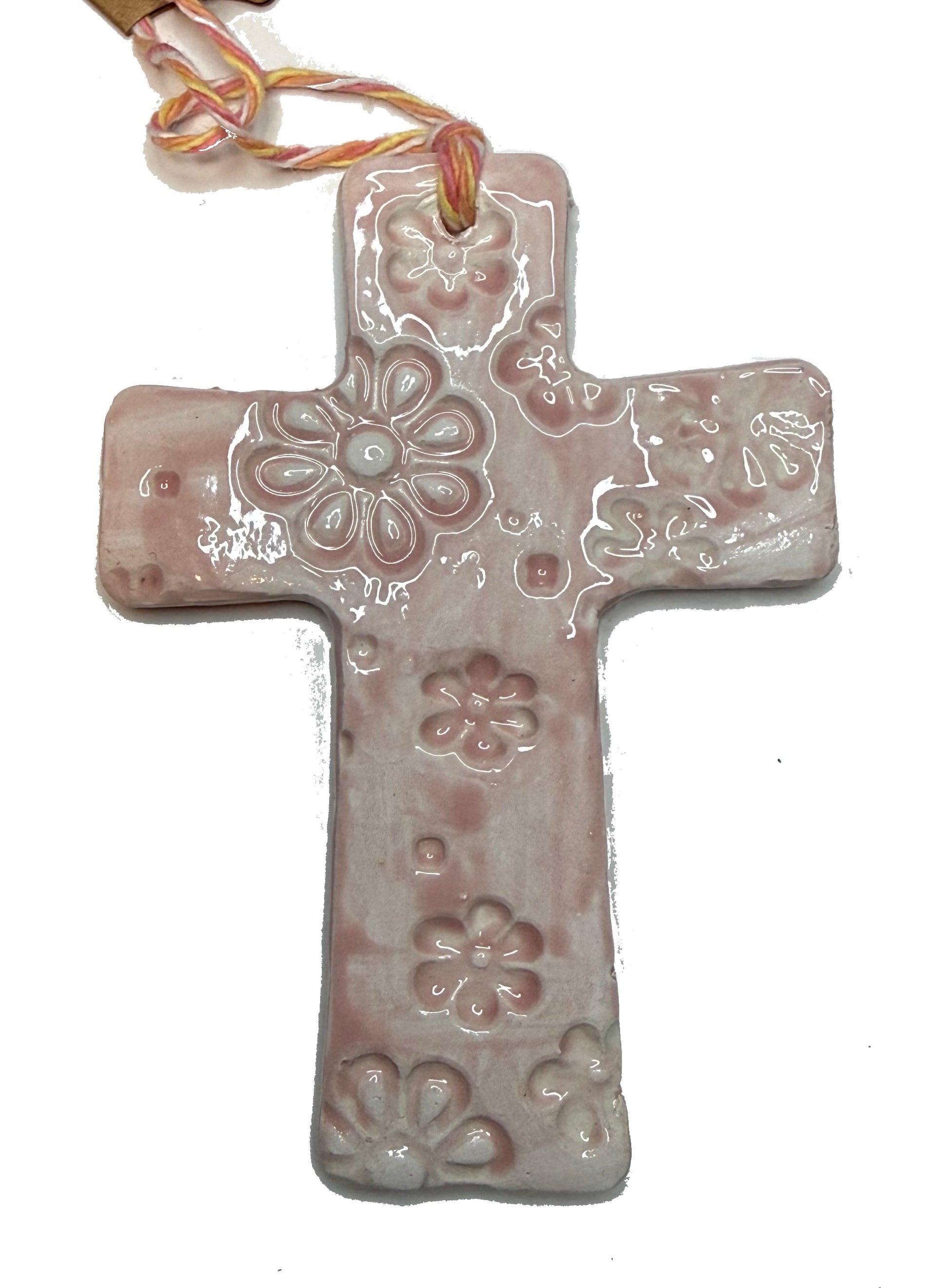 Pink floral cross pendant by Lorena Williams featuring intricate flower engravings and a delicate chain.