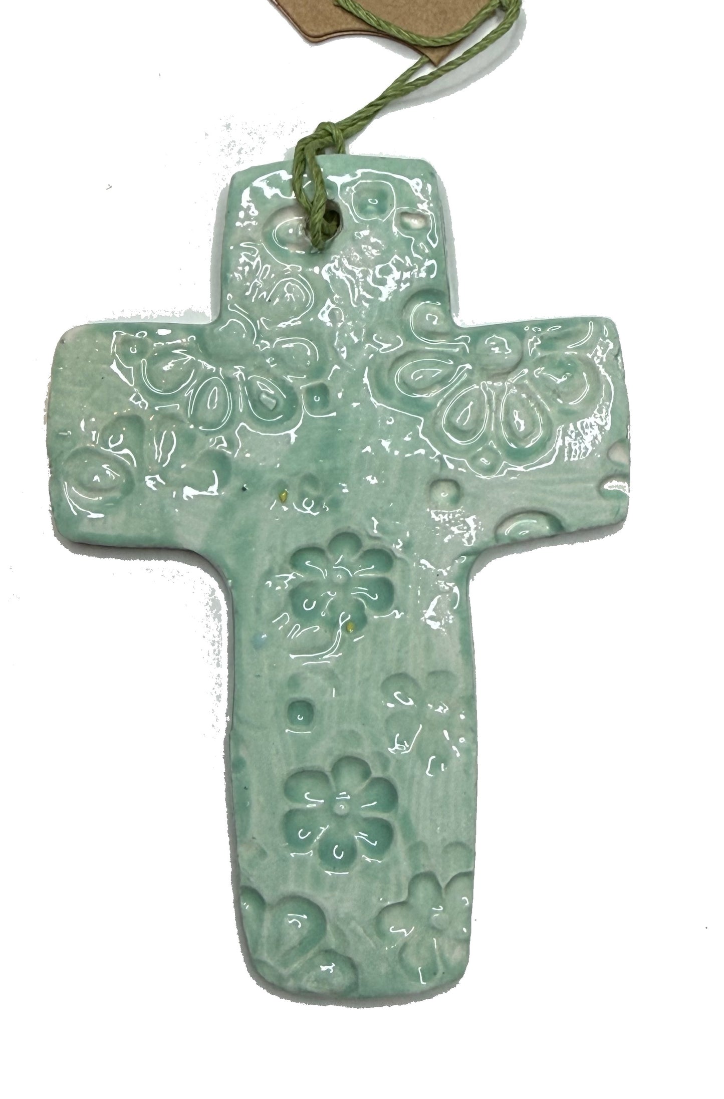 Green flowers ceramic cross by Lorena Williams, featuring detailed painted floral design on a smooth ceramic surface.