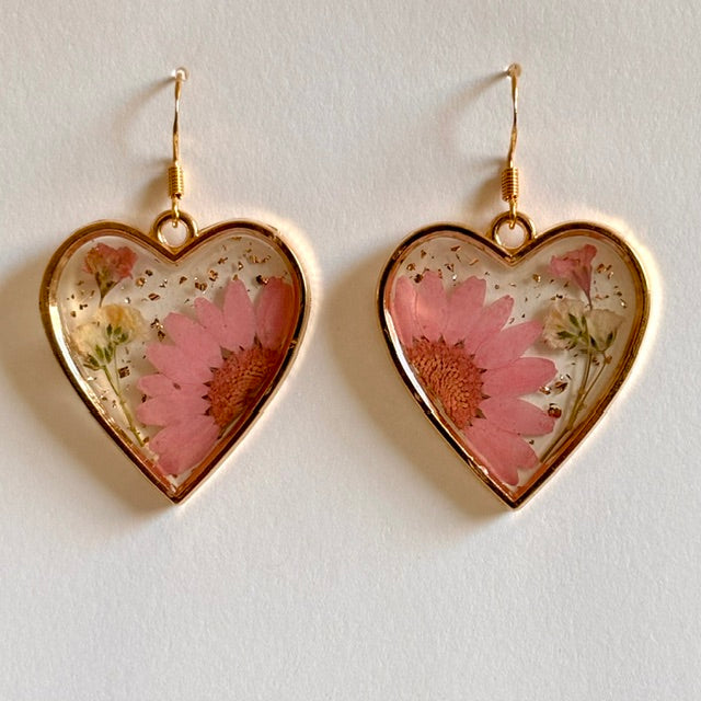 Resin floral heart dangle earrings with colorful flower designs, handcrafted jewelry accessory from Ysleta Mission Gift Shop.