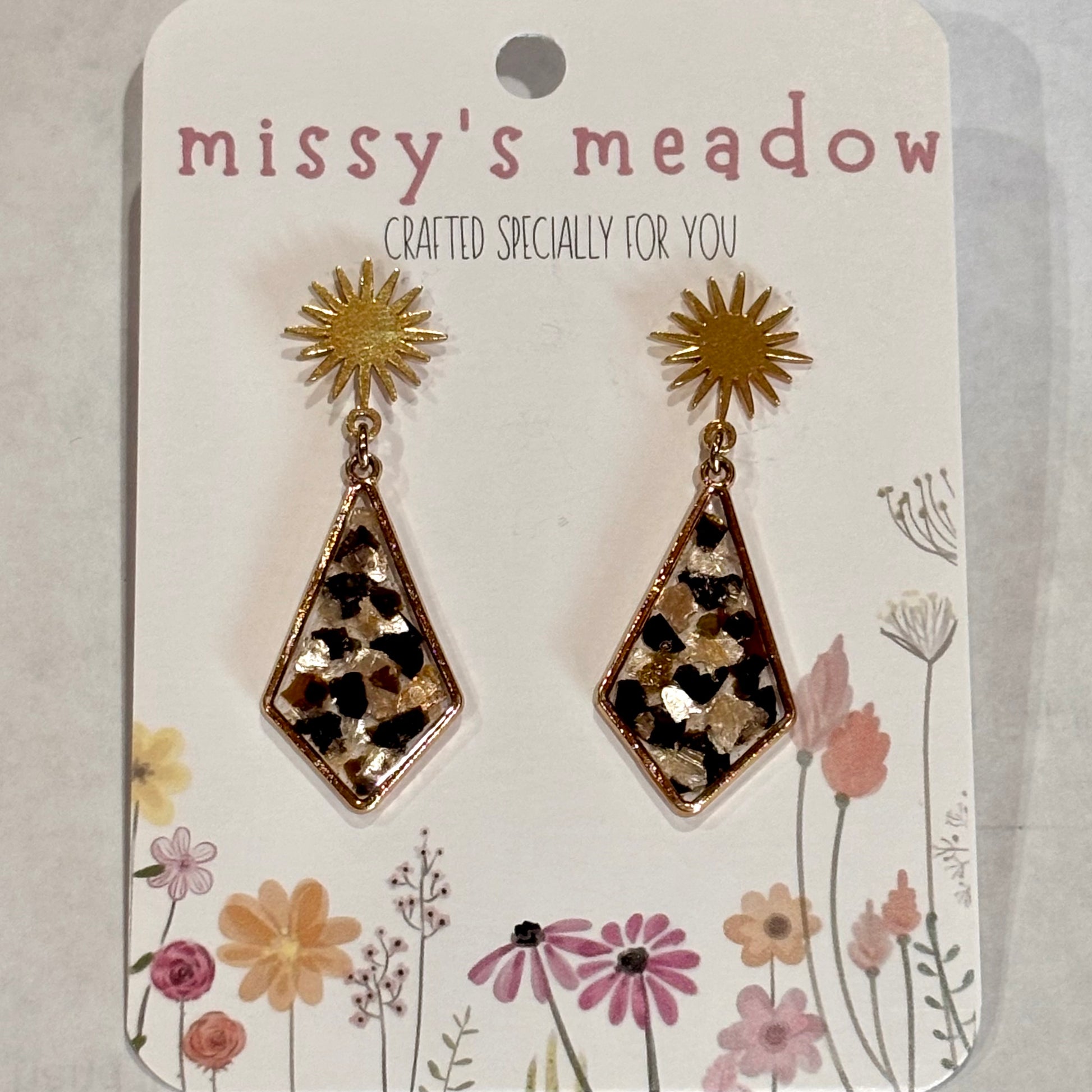 Goldtone sun stud earrings with resin marble flakes in pearl and black, 1.5 inches long by 0.5 inches wide, by Melissa Cortinas.