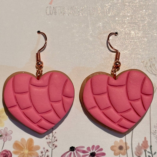 Pink polymer clay concha heart earrings with rose gold hooks, lightweight, handcrafted jewelry by Melissa Cortinas.