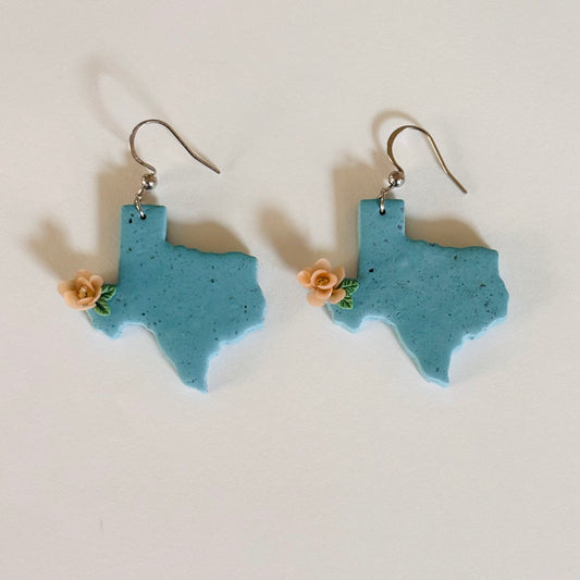 Colorful Texas polymer clay earrings from Ysleta Mission Gift Shop, featuring intricate Native American-inspired designs.