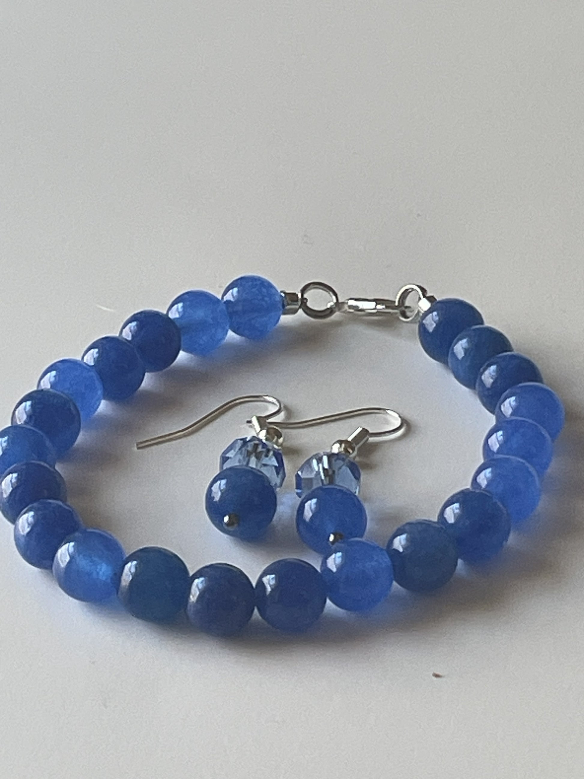 7-inch bracelet and matching earrings set with 8mm blue Kyanite beads, silver lobster clasp, and earring hooks by Sylvia Leroux.