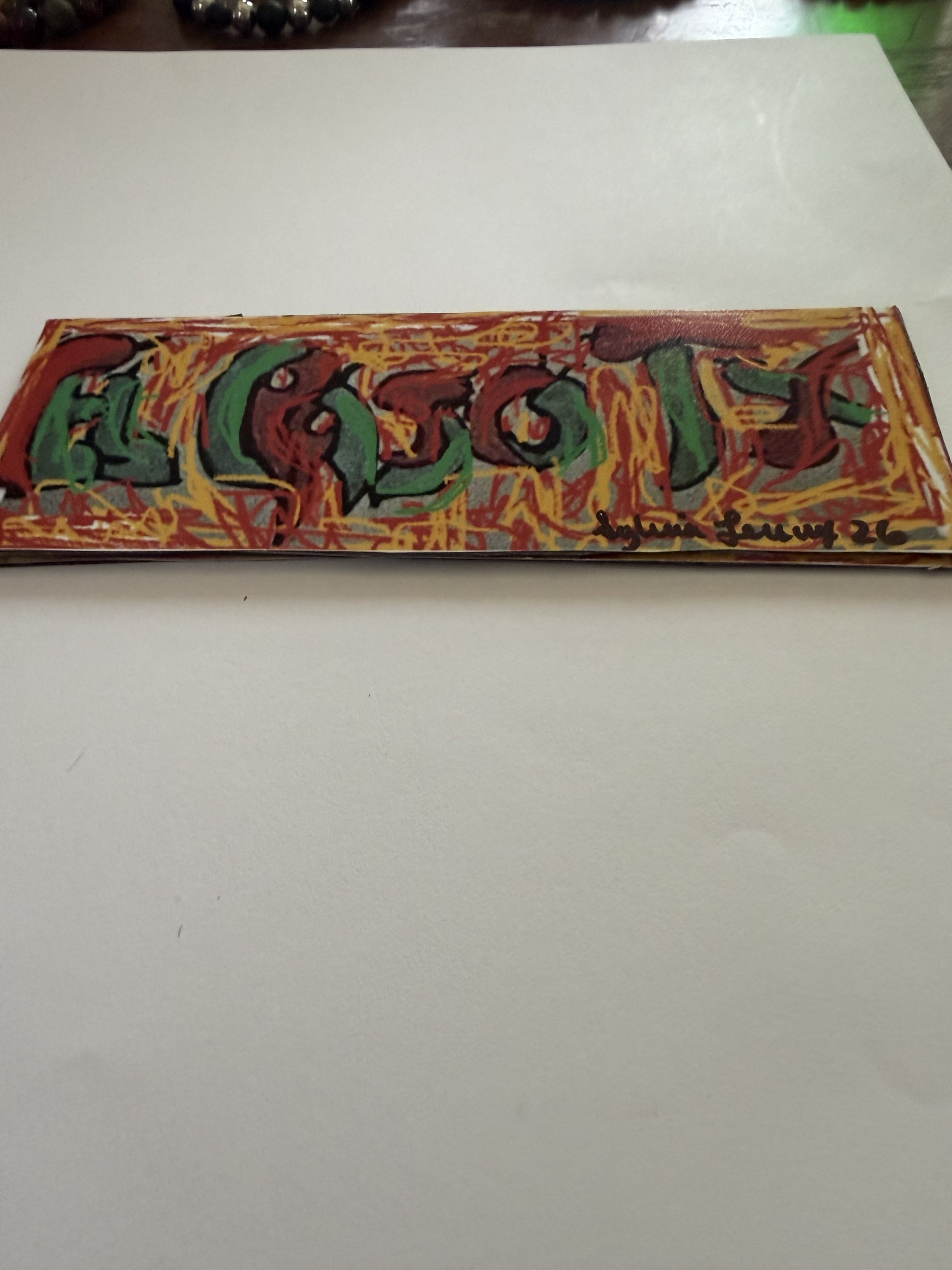 El Paso Chili Pepper Letter Magnet by Sylvia Leroux showing colorful red and green chili peppers on a yellow background.