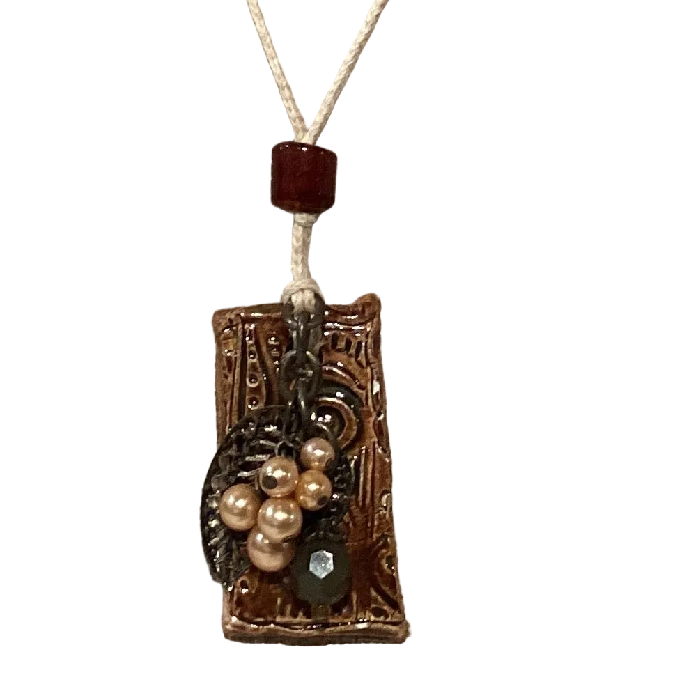 Handmade Mother Nature clay pendant necklace with glass beads, pearls, and metal accents on cotton cord, 13 inches long.
