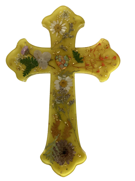 Yellow resin Catholic cross with floral inlay and heart centerpiece, handcrafted wall decor, measuring 9x6 inches by Brigitte Rosson.