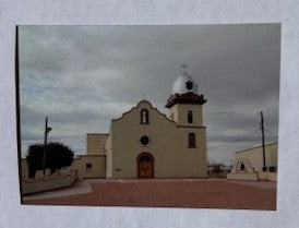 Ysleta Mission grey sky souvenir magnet by Miguel Martinez showing the historic mission building and surrounding landscape.