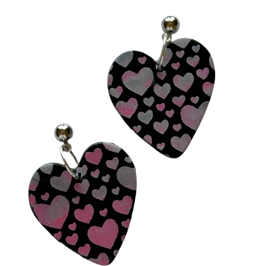 Black polymer clay statement earrings with tiny heart details, 1.5 inches long, by Lorena Williams jewelry and accessories.