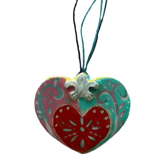 Blue and pink sculpted clay heart ornament by Lorena Williams, measuring 2x2.5 inches, decorative home and garden ornament.