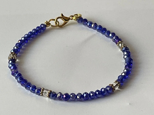 Blue and clear faceted beaded bracelet from Sylvia Leroux, 7-inch jewelry accessory with polished gemstone beads.