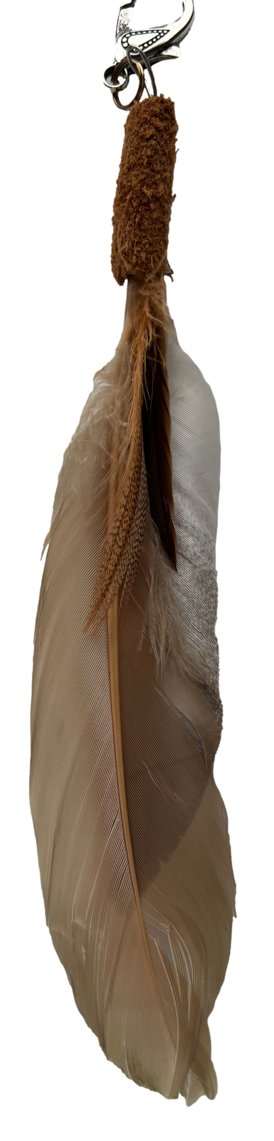 Brown feather tassel keychain by Consuelo Barraza with a leather strap and metal clasp for handbags or accessories.