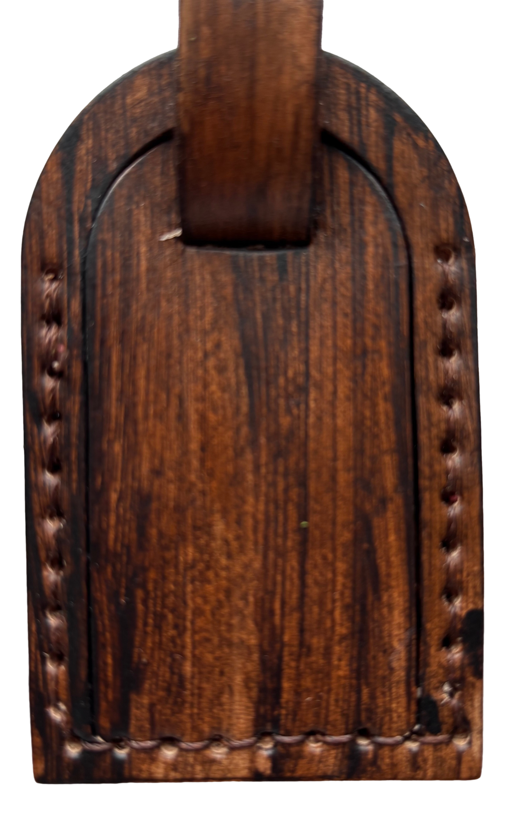 Brown leather luggage tag by Consuelo Barraza with embossed branding, designed for secure identification on travel bags.