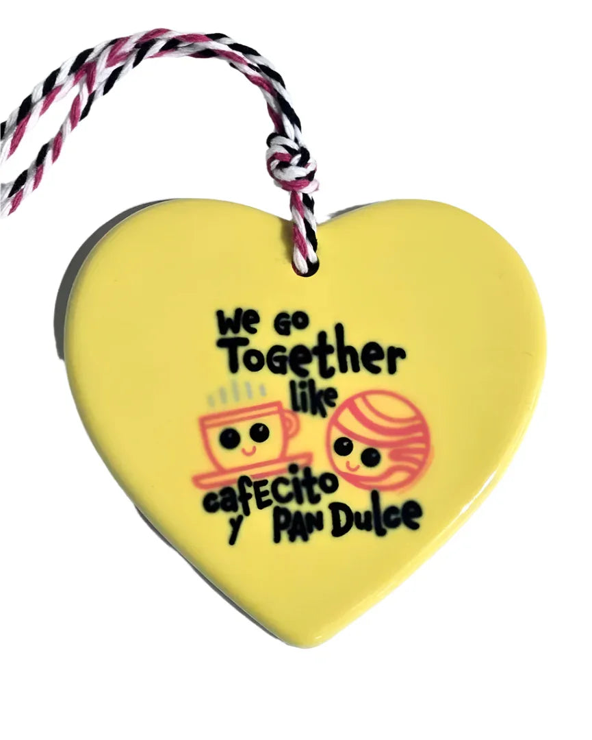 Handcrafted ceramic heart ornament featuring a coffee and pan design, ideal for kitchen decor or gift, by Vanessa Clark.