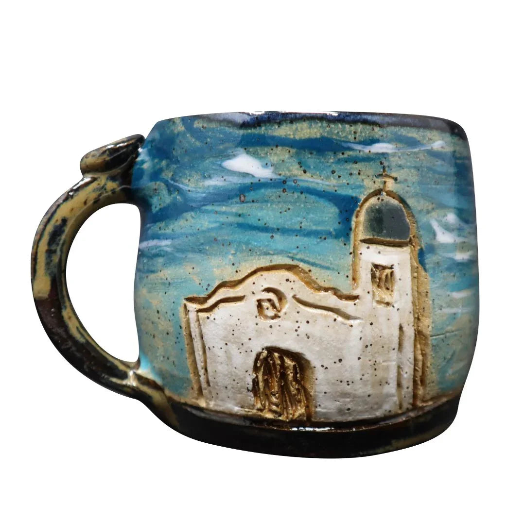 Hand-carved ceramic mug featuring El Paso Mission Trail design by Vanessa Clark, ideal for souvenirs and gift collection.
