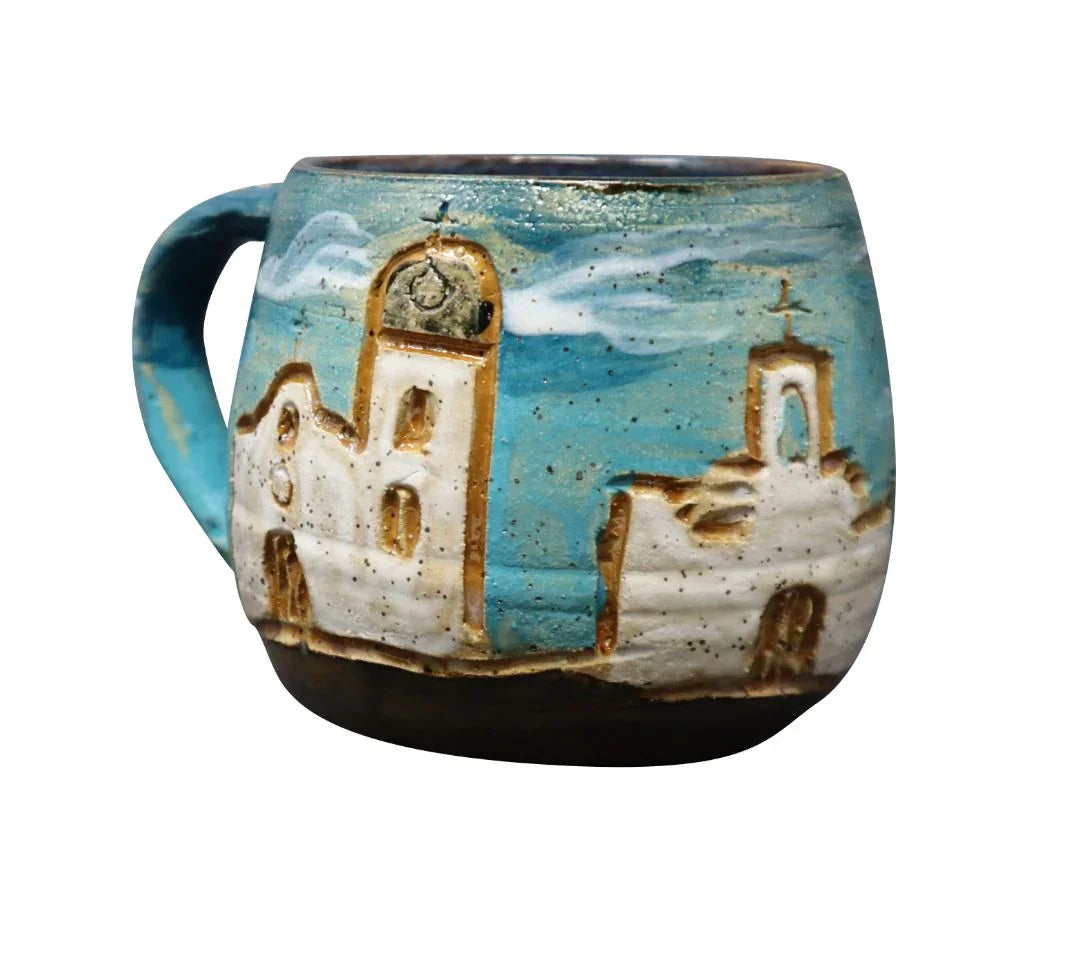 Hand-carved ceramic mug featuring El Paso Mission Trail design by Vanessa Clark, perfect for souvenirs and drinkware.