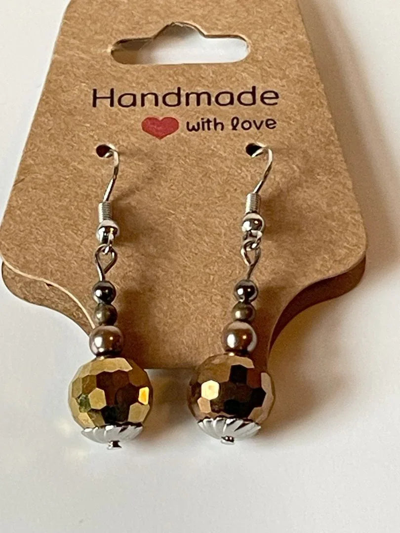 Copper gold faceted glass bead earrings by Sylvia Leroux, 1.5 inches long, showcasing shiny, multi-faceted glass beads in a stylish design.
